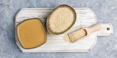 bowl-tahini-with-sesame-seeds-concrete-surface_114579-5518-1