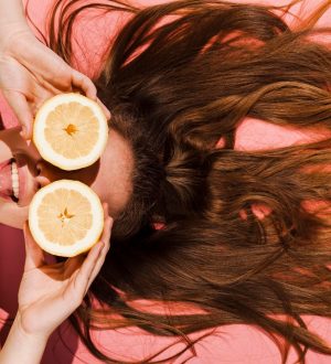 close-up-woman-posing-with-orange_23-2148545956